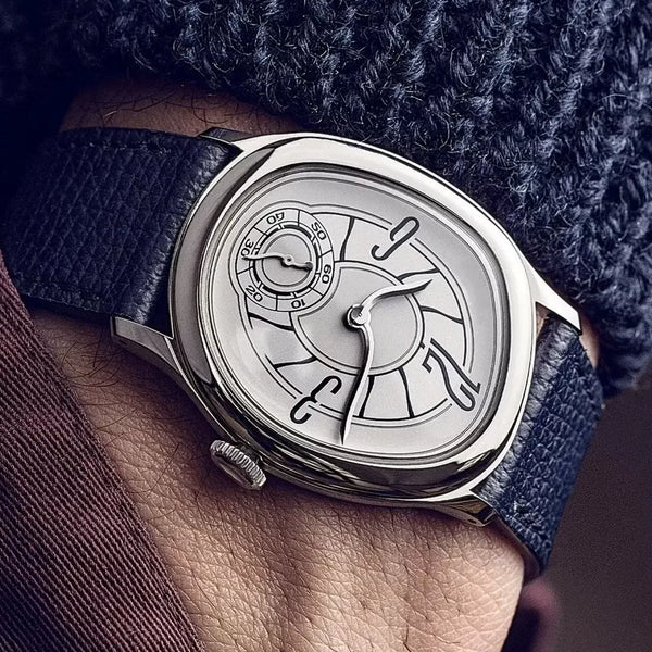 Silver Tiziano watch on the wrist below a navy knit sweater sleeve