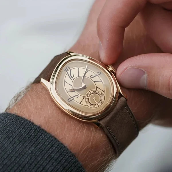 Hand adjusting the crown of the rose gold tone Tiziano on a taupe leather strap