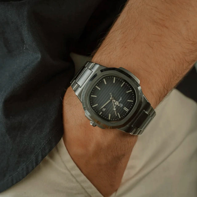 Tremezzo worn with a dark shirt and chinos, black dial catching indoor light