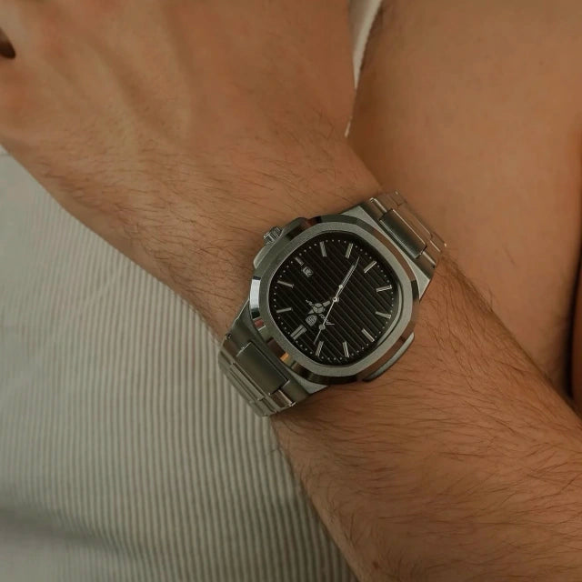 Tremezzo with black dial worn on a wrist, showing how low the case sits
