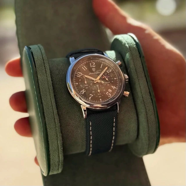 Lunario chronograph resting on a green suede watch roll, case profile in view