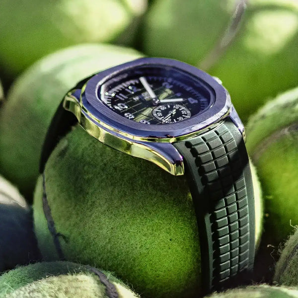 Portofino sport watch in green resting on a pile of tennis balls