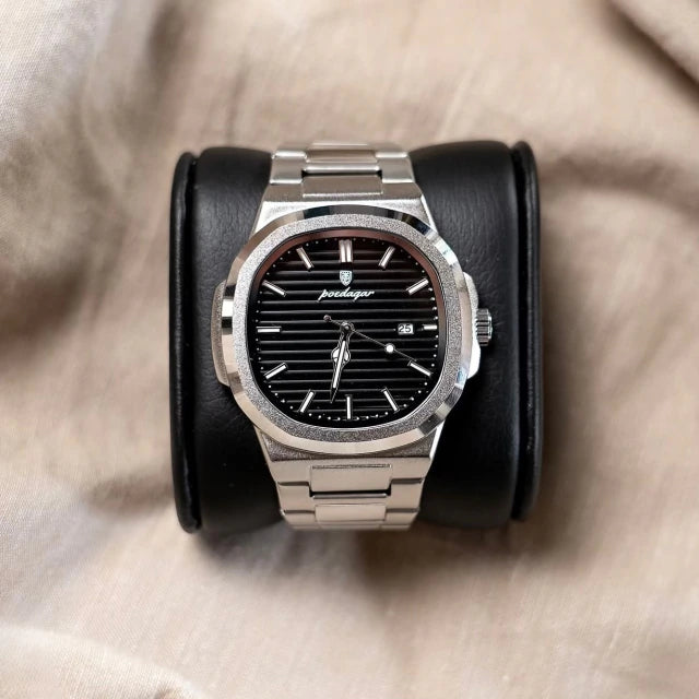 Tremezzo with black dial resting on a leather watch cushion, grained bezel visible